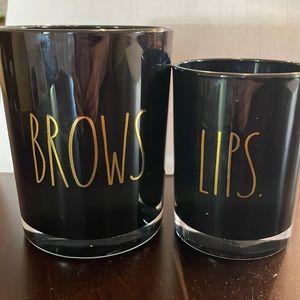 Rae Dunn, set of 2 “Brows” and “Lips” black glass holders